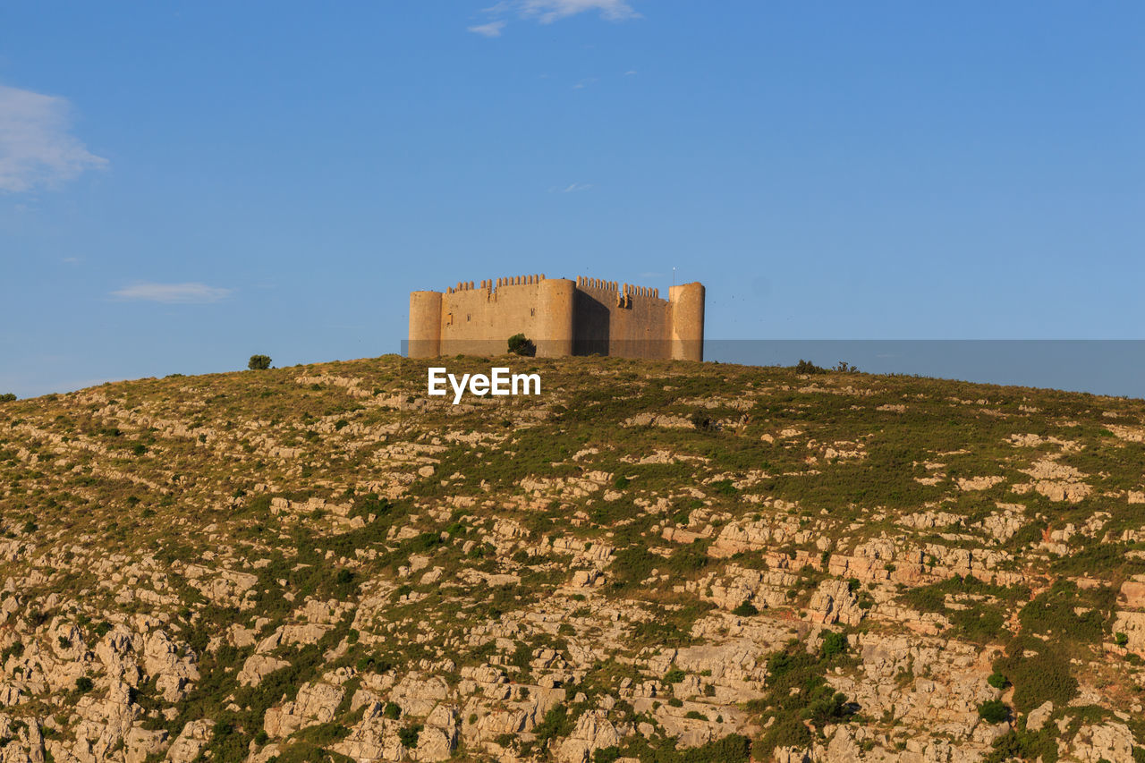 The medieval castle of montgri in gerona with mountain. concept of ancient constructions 