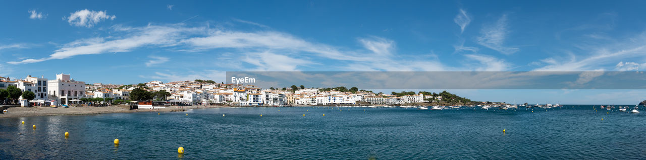 Panoramic view of sea and buildings against sky