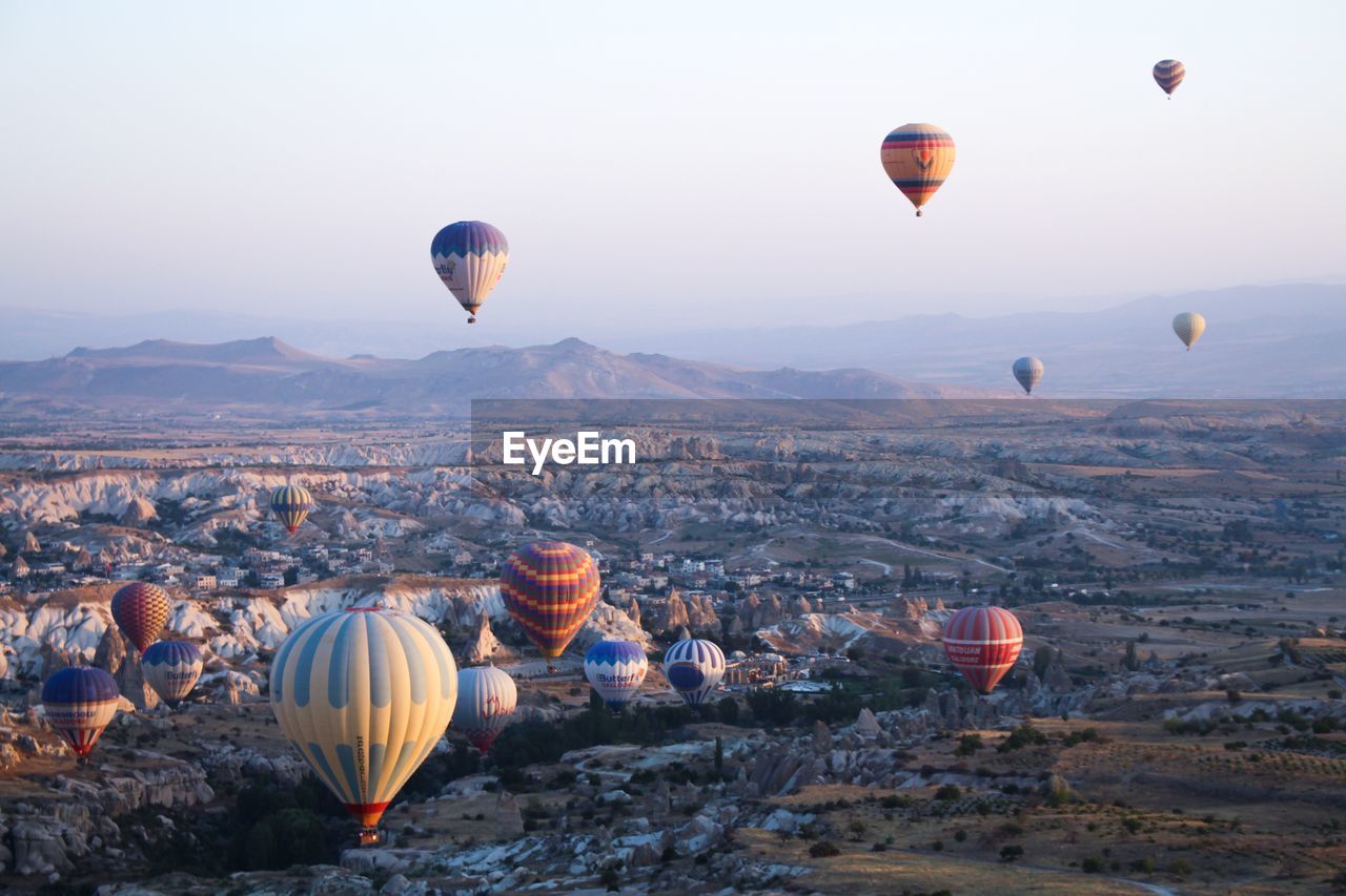 HOT AIR BALLOON FLYING OVER LANDSCAPE