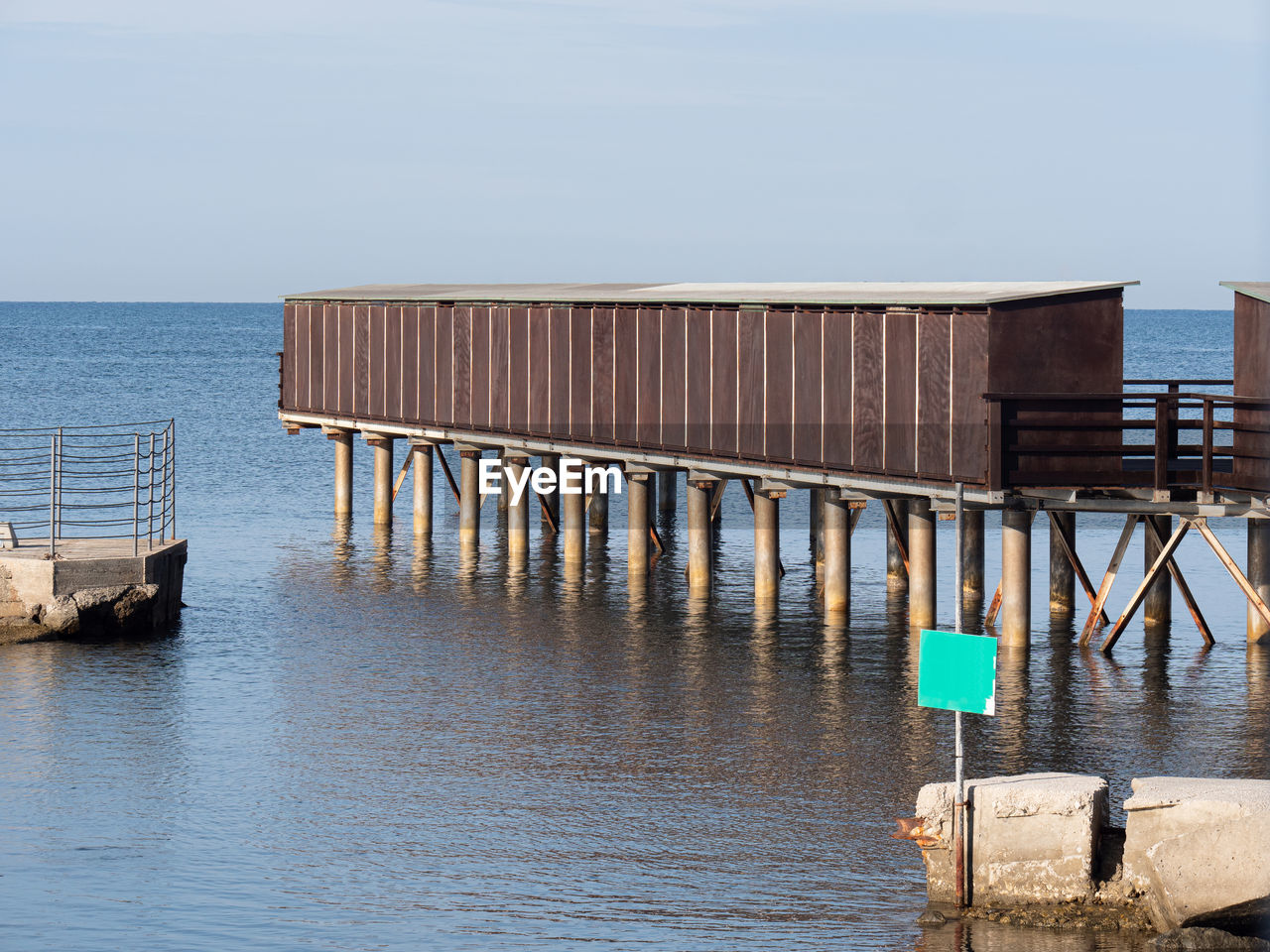 Wooden construction on stilts on the sea along the coast.