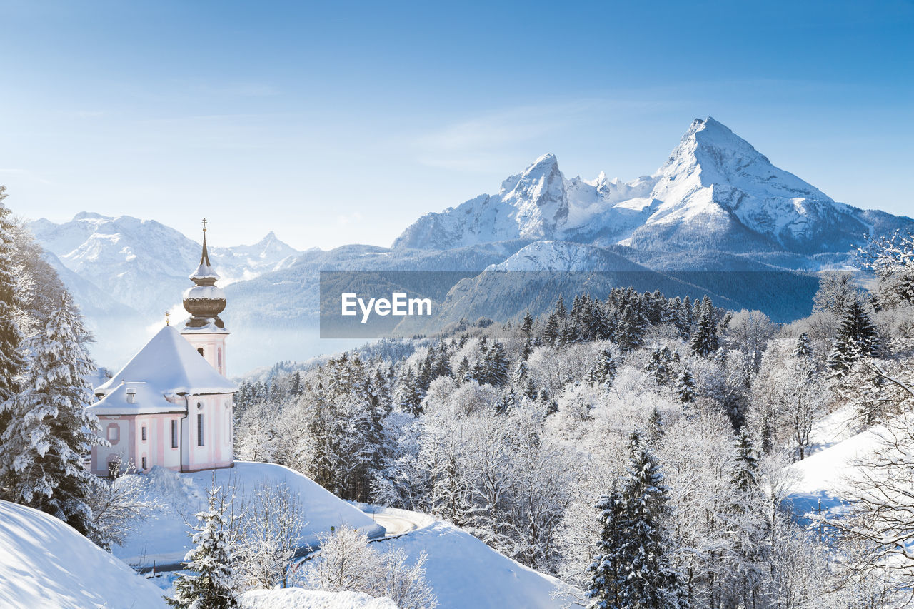 Building against snow covered mountain and sky