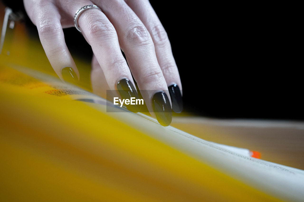 Cropped hand of woman on table