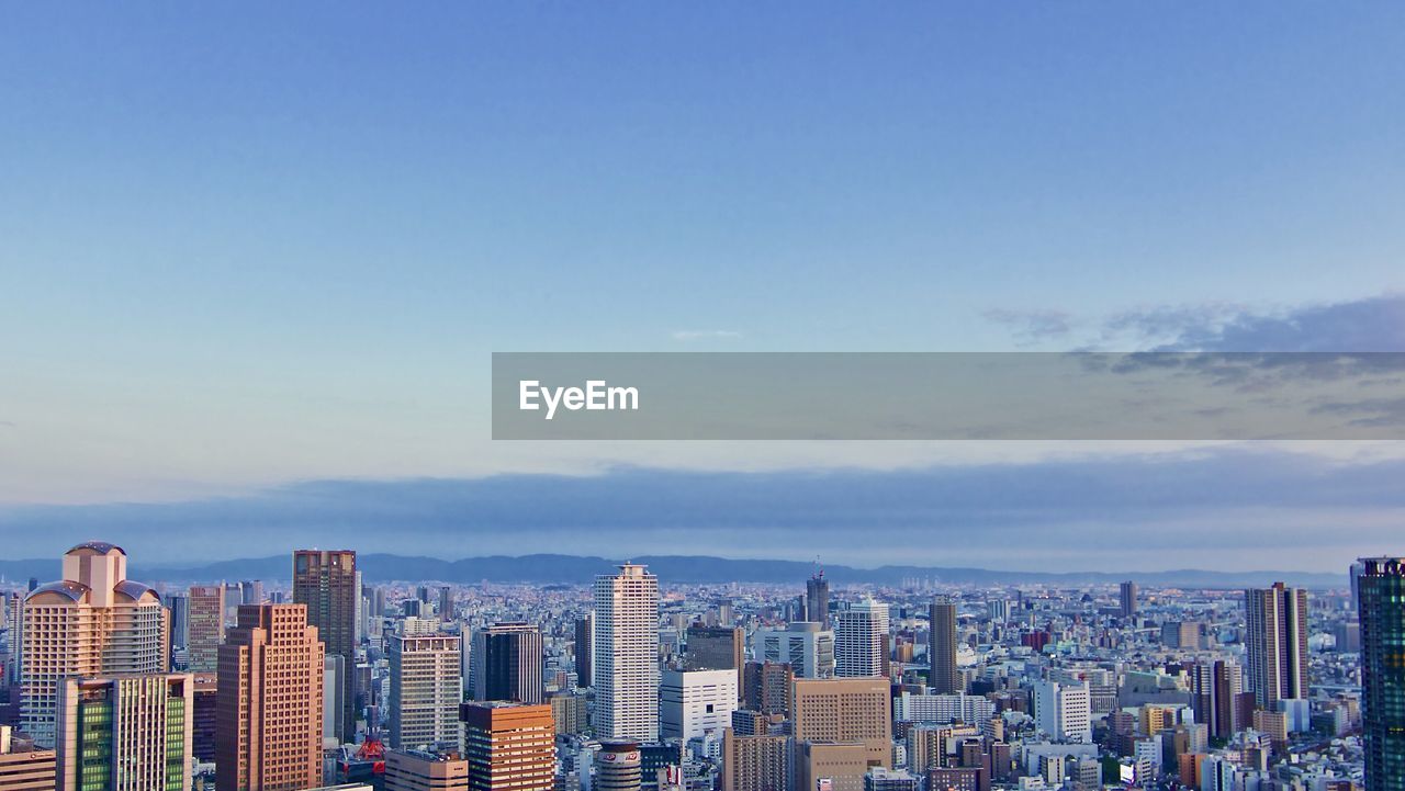 Aerial view of modern buildings in city against sky