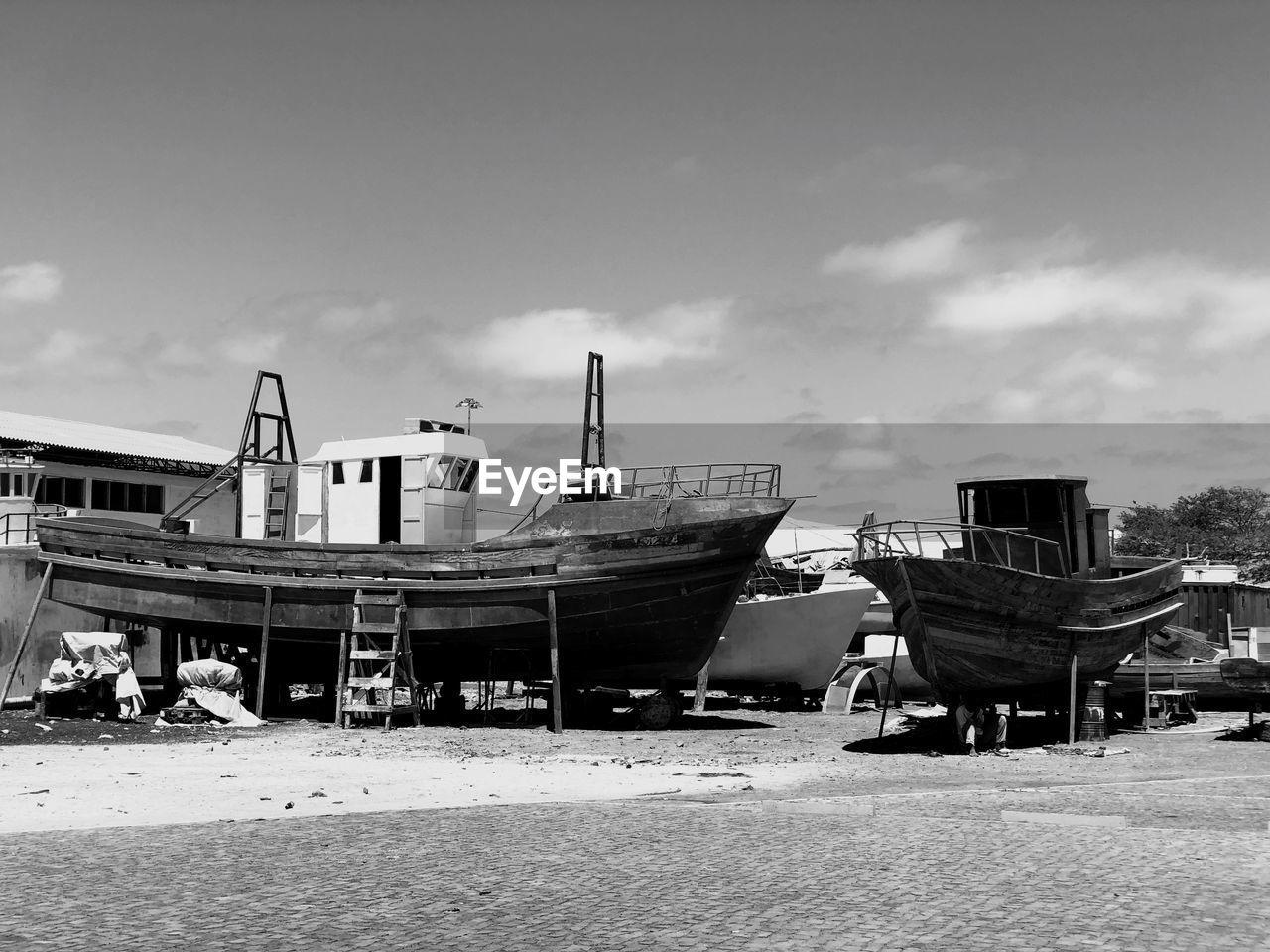 Boats moored on beach against sky