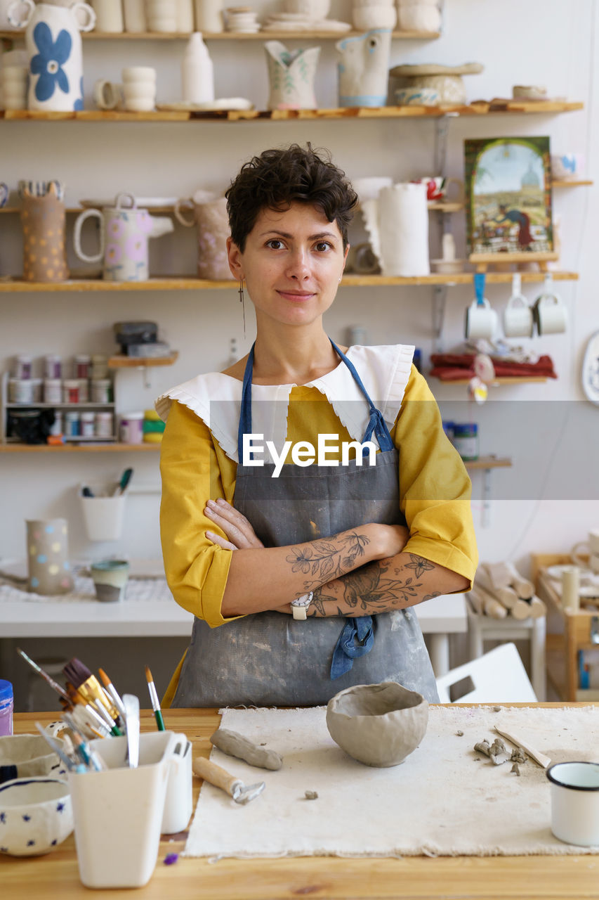 Successful ceramics studio or small business owner woman at workplace in pottery studio workshop