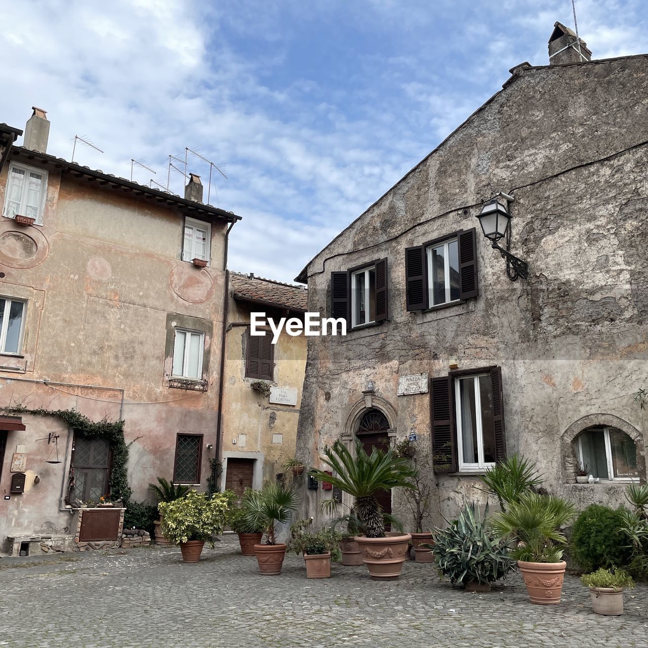 architecture, building exterior, built structure, village, building, town, window, neighbourhood, flowerpot, estate, nature, residential district, house, sky, city, no people, plant, facade, cloud, cottage, outdoors, street, residential area, day, old, potted plant, home, houseplant