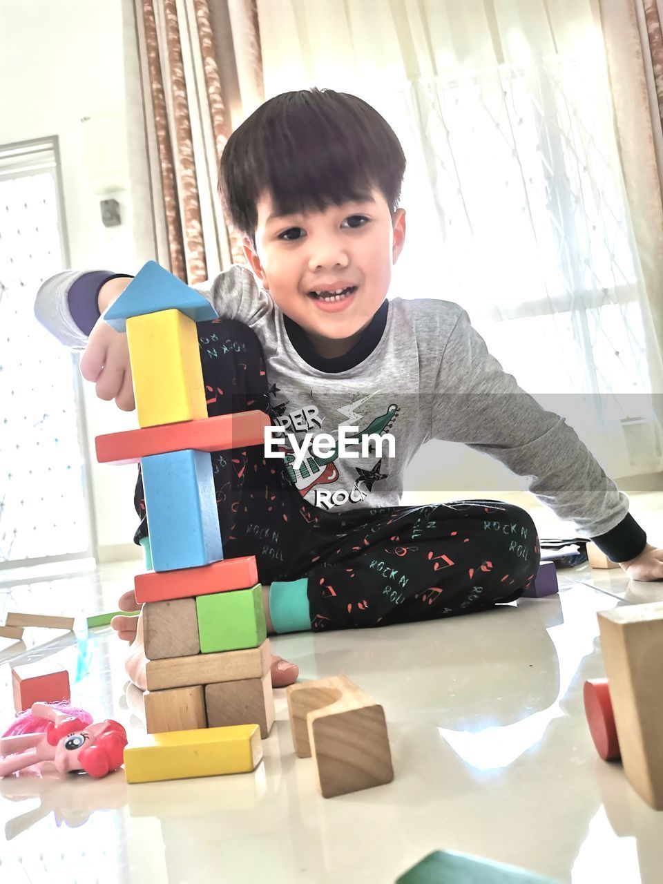 Portrait of boy with toys at home