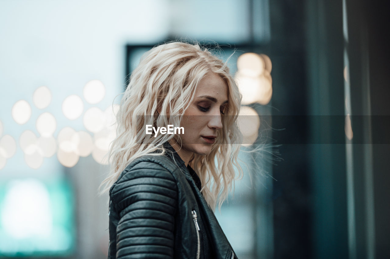 Portrait of young woman looking away outdoors