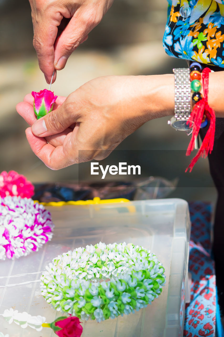 Close-up of woman making flower bouquet