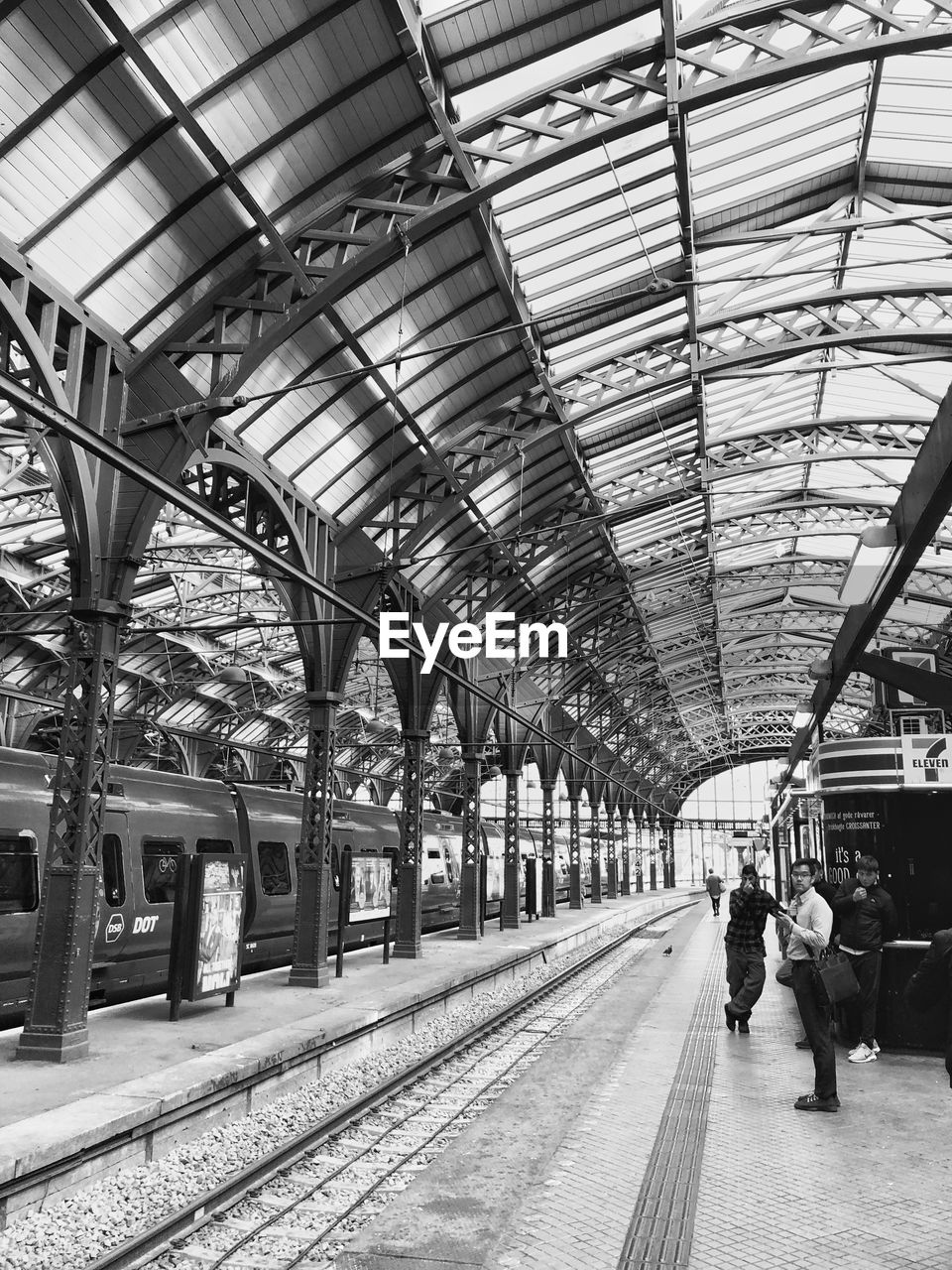 PEOPLE ON RAILROAD STATION PLATFORM