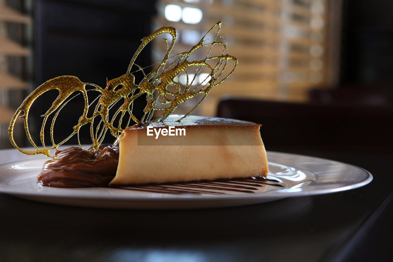 Close-up of caramel custard in plate on table