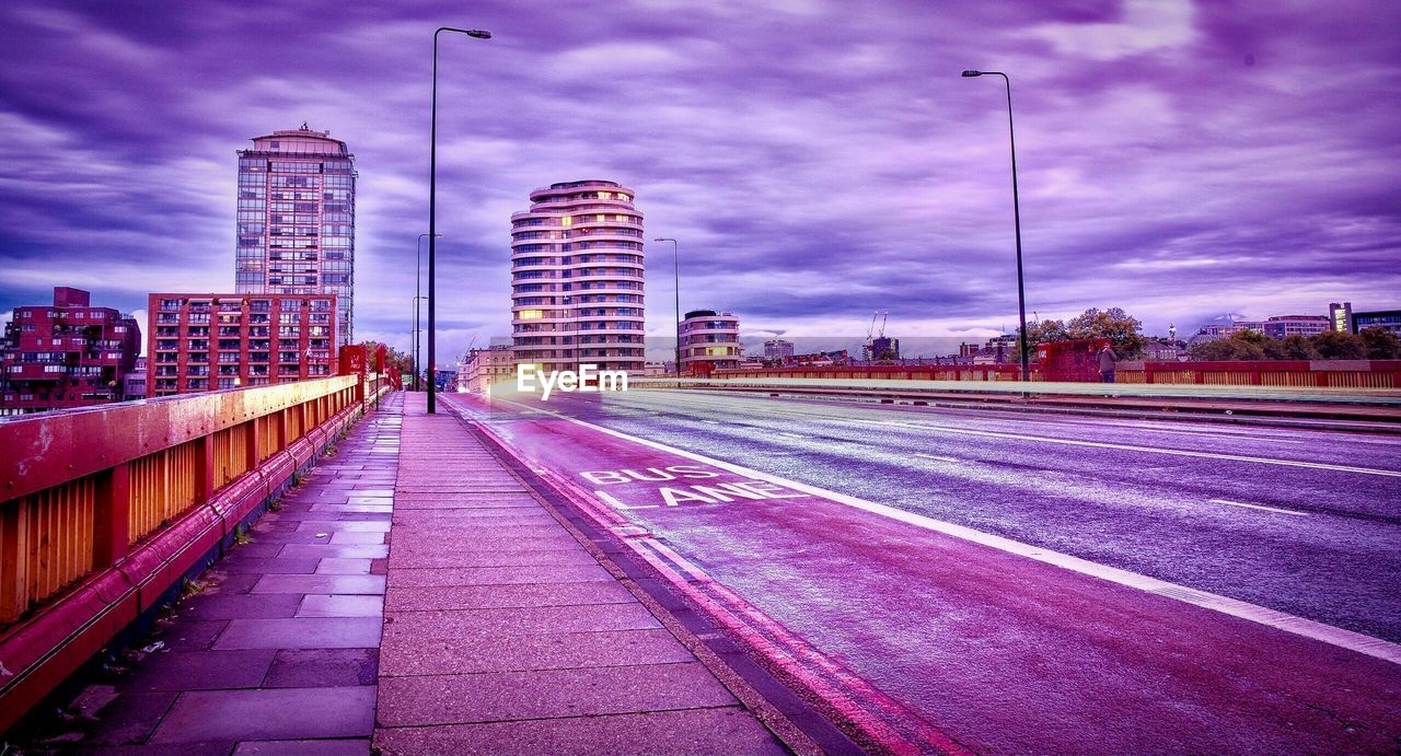 SURFACE LEVEL OF EMPTY ROAD AGAINST BUILDINGS