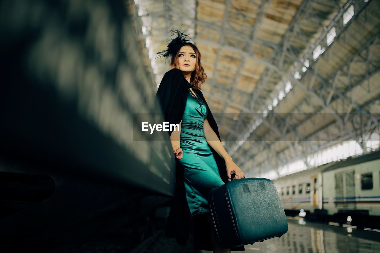 Young woman waiting for the arrival of the train at the station