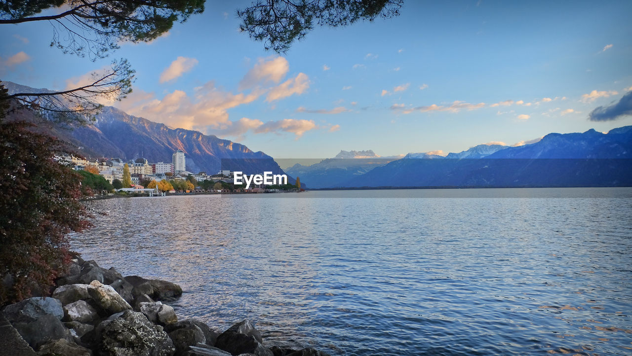 water, mountain, scenics - nature, sky, beauty in nature, reflection, nature, body of water, mountain range, tranquility, tranquil scene, lake, cloud, landscape, environment, land, tree, travel destinations, no people, rock, travel, idyllic, morning, outdoors, shore, blue, plant, beach, dusk, day, non-urban scene, tourism, reservoir, bay, holiday, vacation