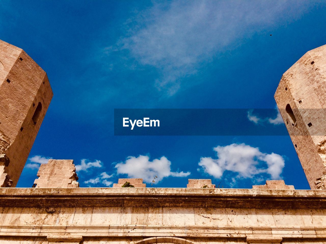 Low angle view of old building against blue sky