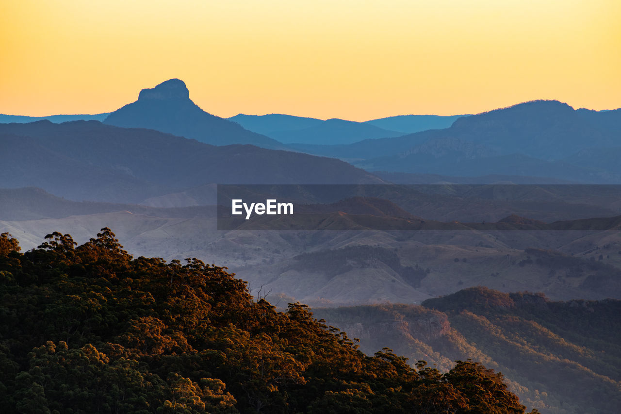 Scenic view of mount lindesay, queensland, australia against clear sky during sunset