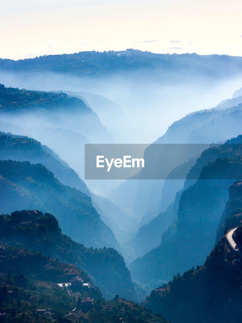 Idyllic shot of mountains in foggy weather