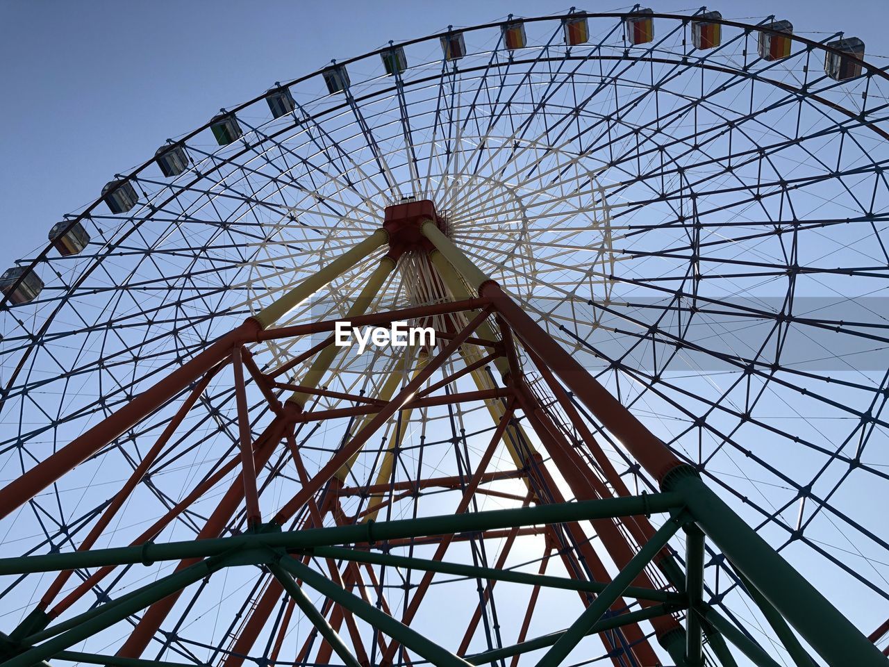 DIRECTLY BELOW SHOT OF FERRIS WHEEL AGAINST SKY