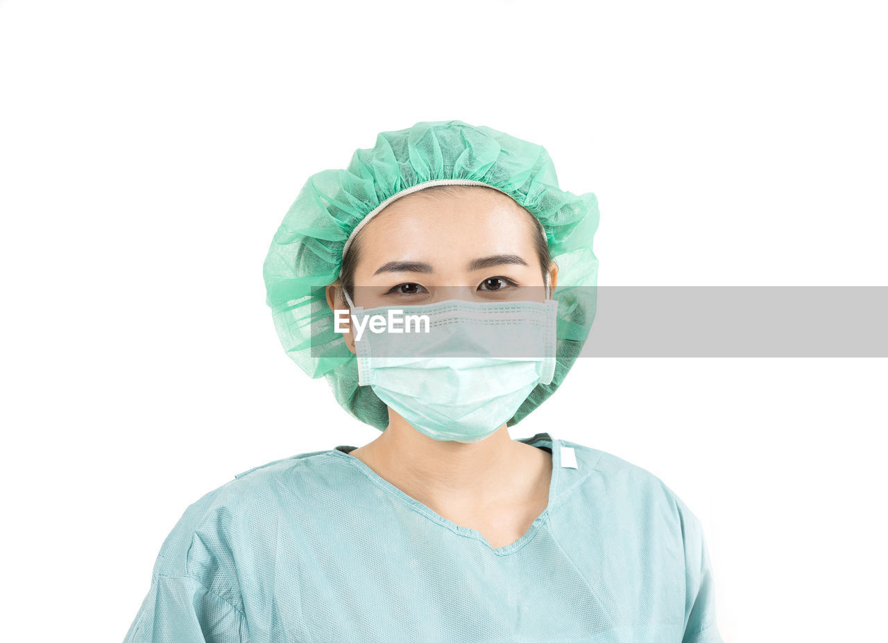 Portrait of surgeon against white background