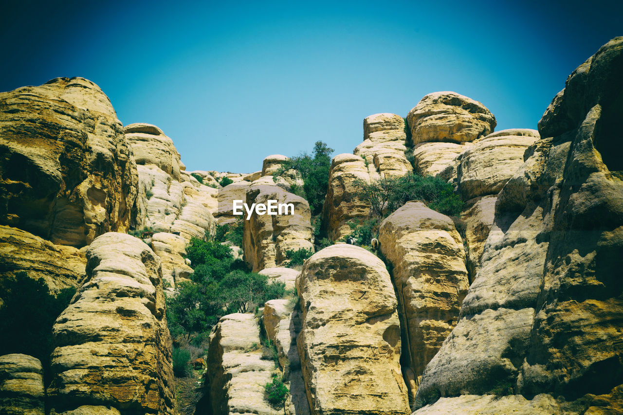 Low angle view of rock formations against sky