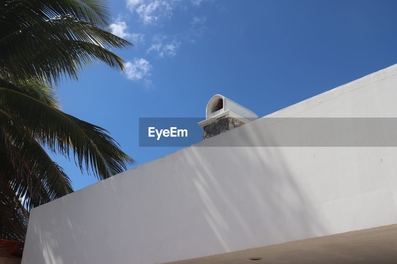 Low angle view of white building against blue sky