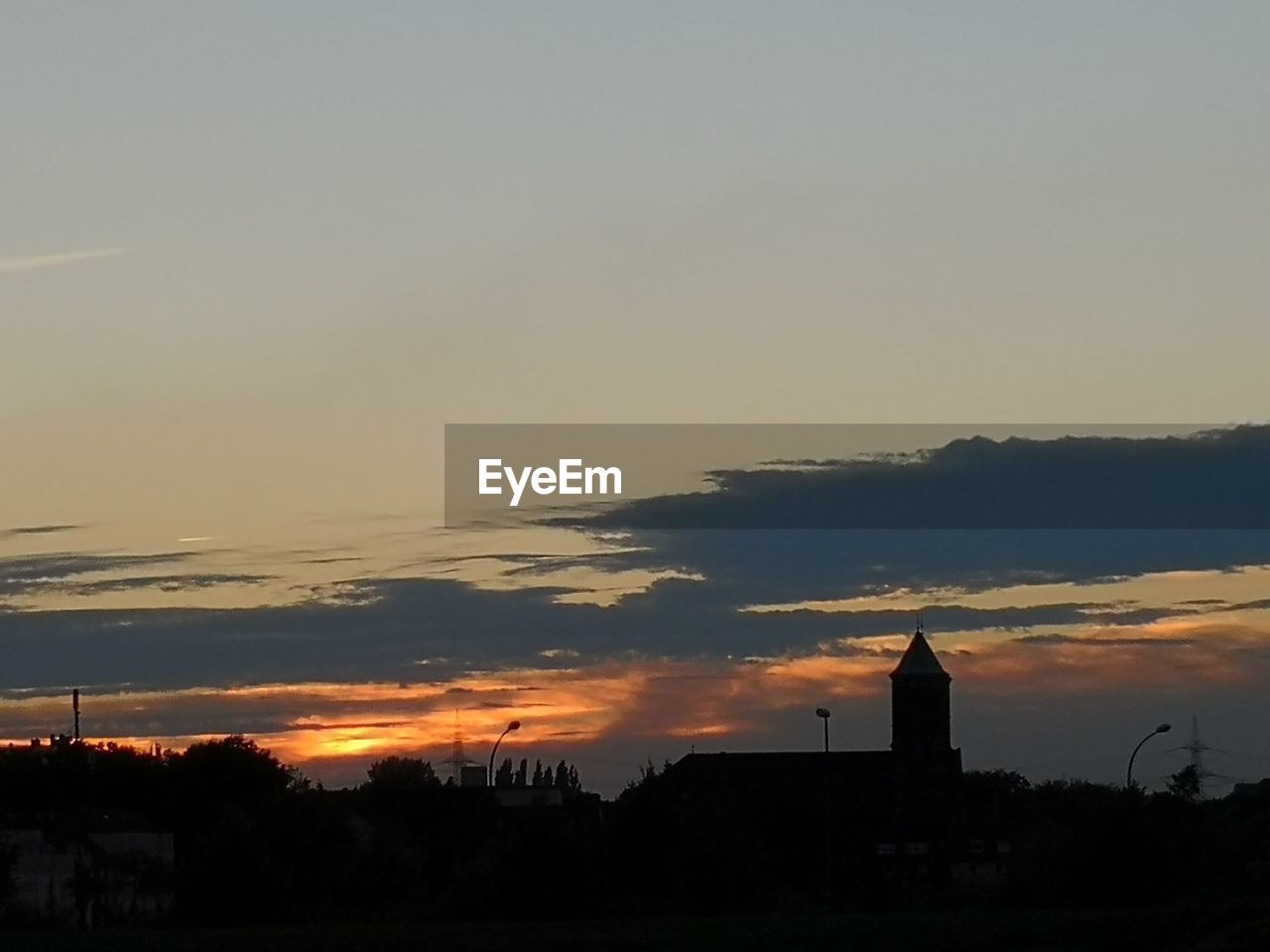 SILHOUETTE OF BUILDING AGAINST SKY DURING SUNSET