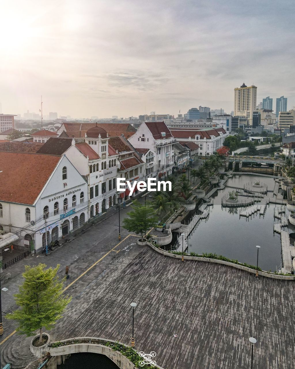 High angle view of buildings by river against sky