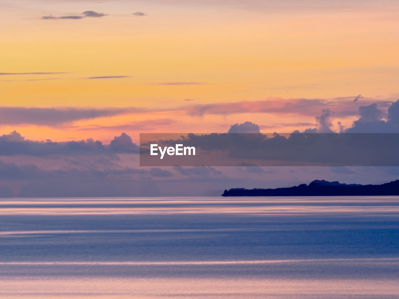 Scenic view of sea against romantic sky at sunset