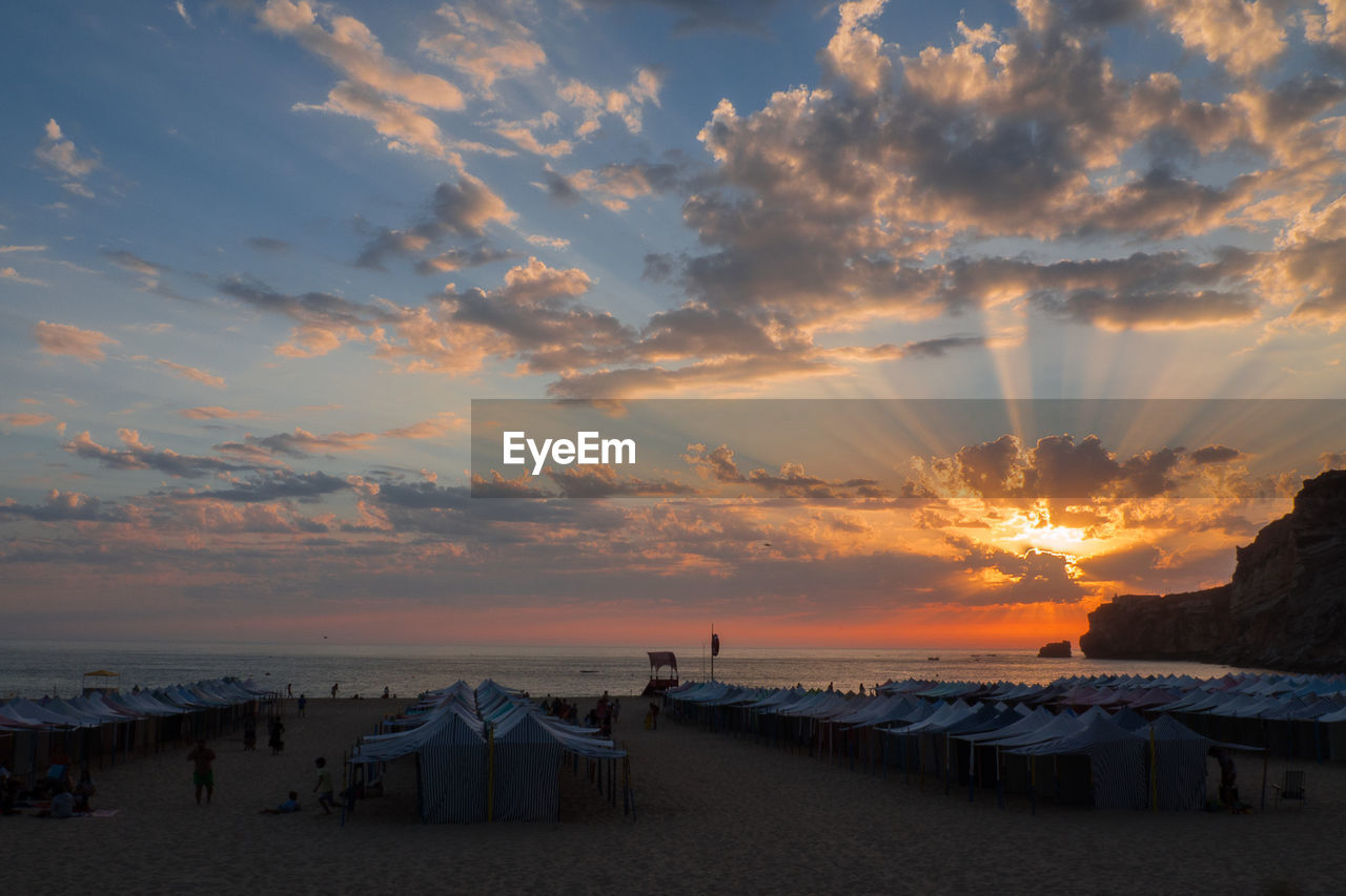 Scenic view of beach against sky during sunset