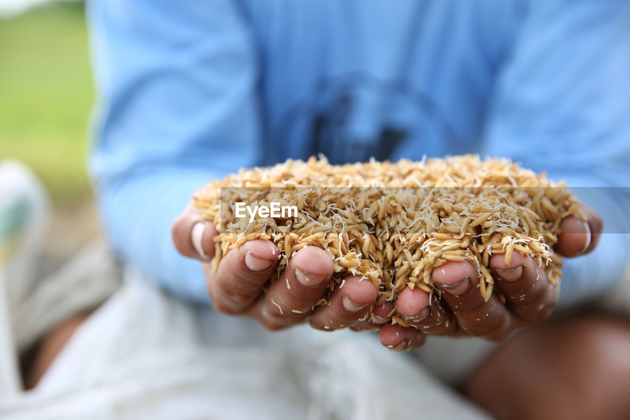 Midsection of man holding food