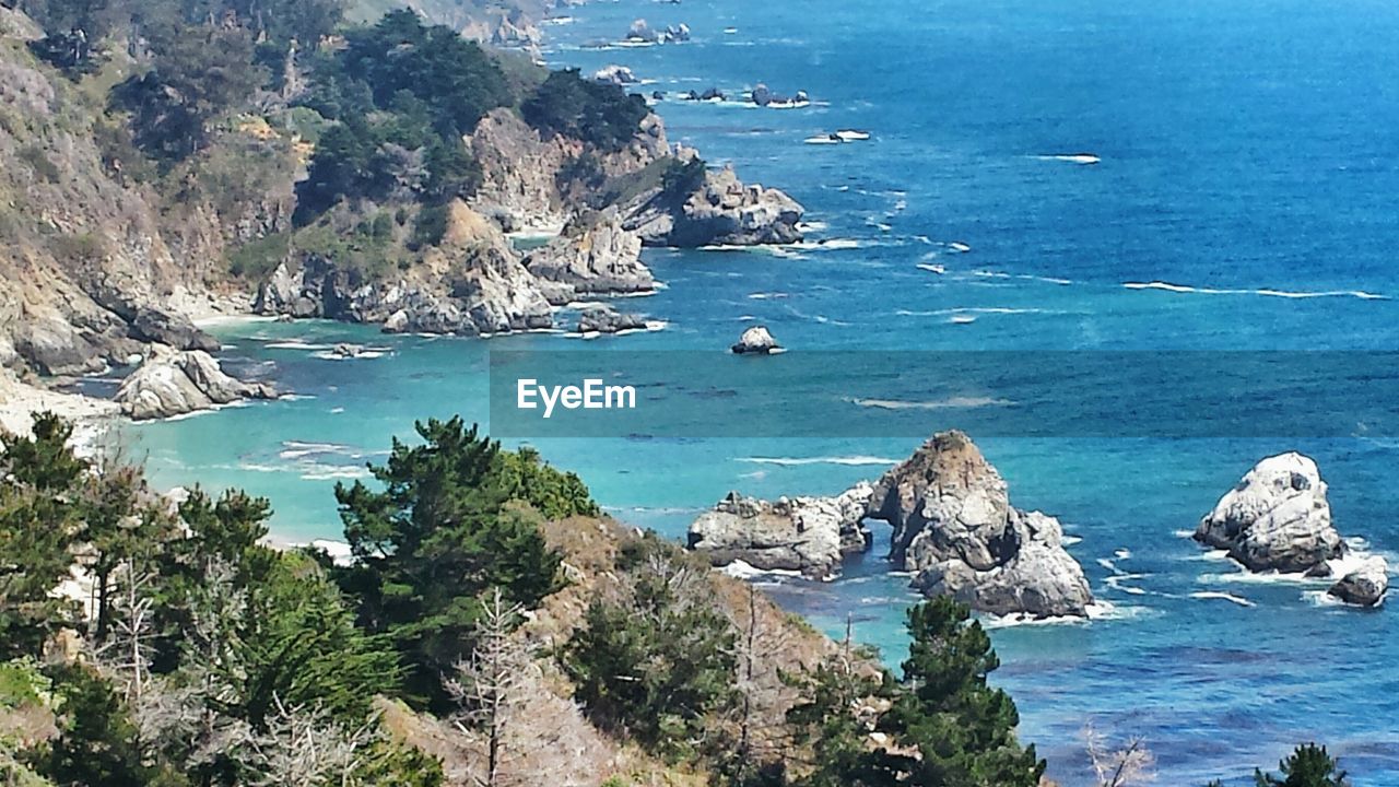 SCENIC VIEW OF SEA WITH MOUNTAIN RANGE IN BACKGROUND