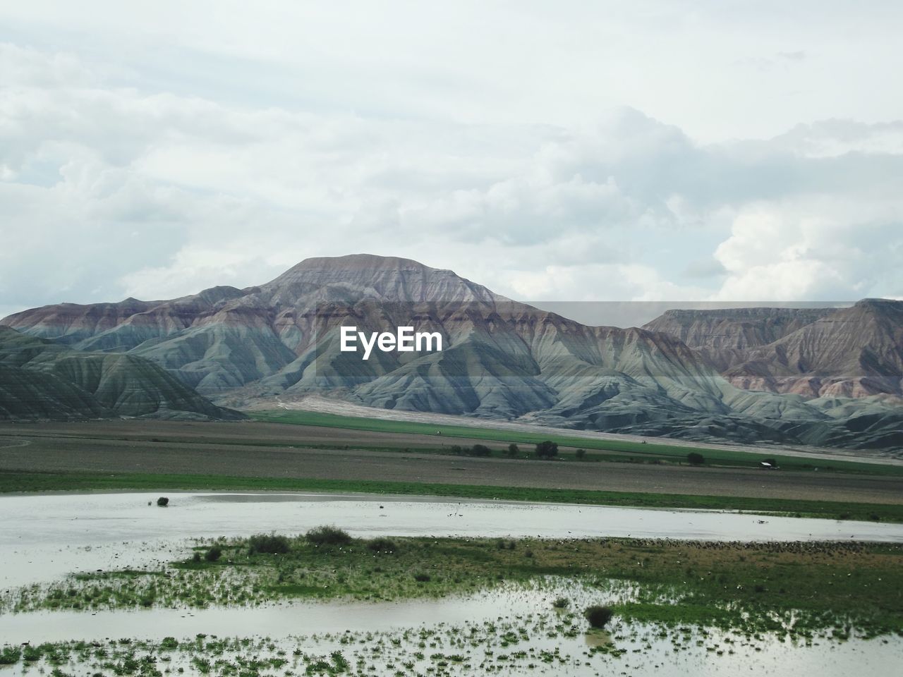 Scenic view of lake and mountains against sky