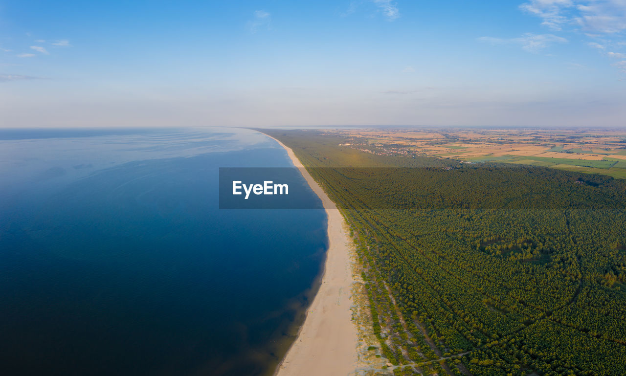 horizon, sea, scenics - nature, water, sky, environment, landscape, nature, coast, land, beauty in nature, aerial view, tranquility, cloud, tranquil scene, aerial photography, sunlight, no people, reflection, hill, morning, ocean, beach, travel, day, outdoors, blue, dawn, natural environment, non-urban scene, plain, idyllic, travel destinations, high angle view, transportation, tourism, coastline, horizon over water, sunrise