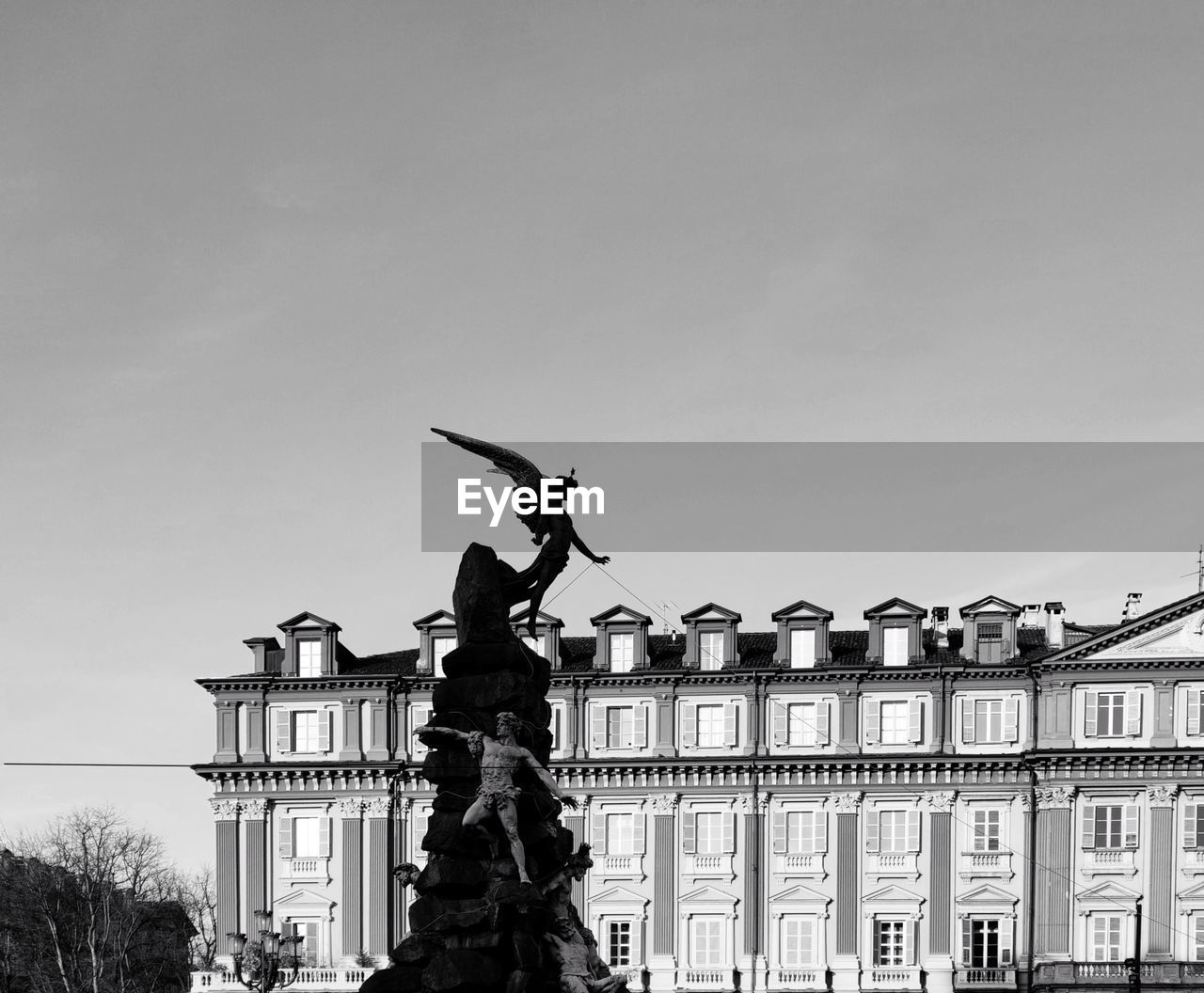 architecture, statue, sculpture, built structure, sky, representation, black and white, building exterior, human representation, monochrome, monochrome photography, history, black, the past, travel destinations, nature, monument, city, animal representation, landmark, male likeness, creativity, day, no people, memorial, tree, travel, building, tourism, outdoors, clear sky, low angle view, craft, government