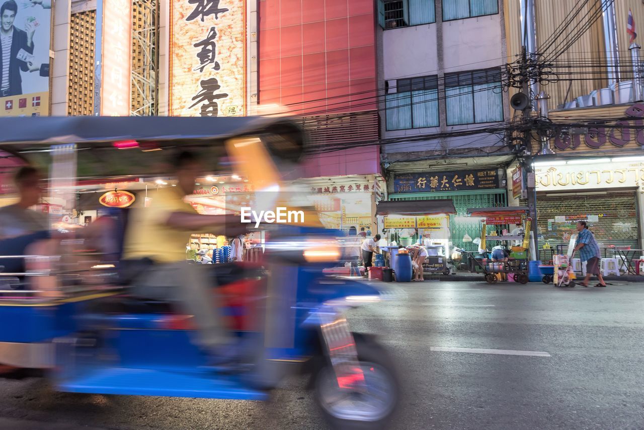 Blurred motion of  motorcycle and people in bangkok chinatown