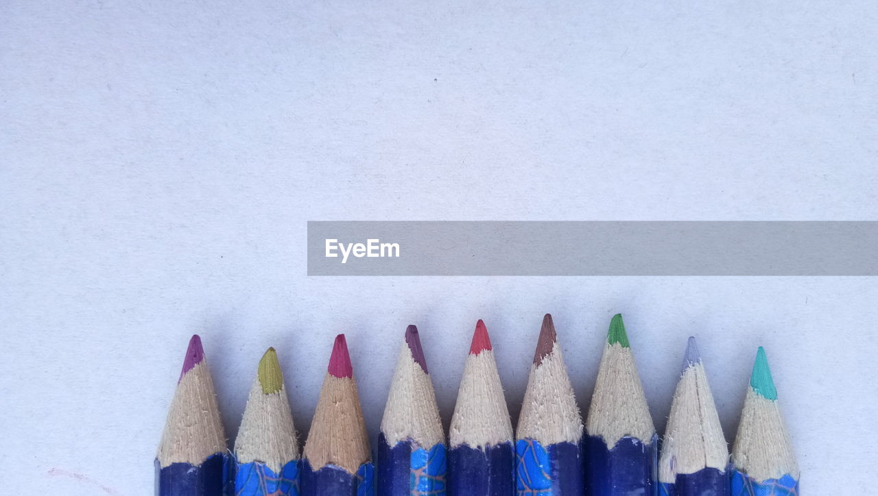 Close-up of colored pencils against white background