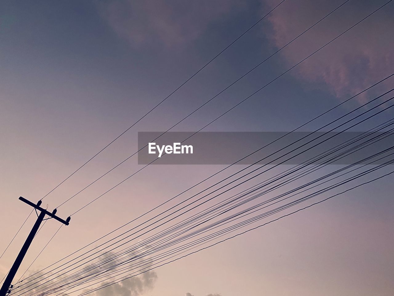 Low angle view of electricity pylon against sky