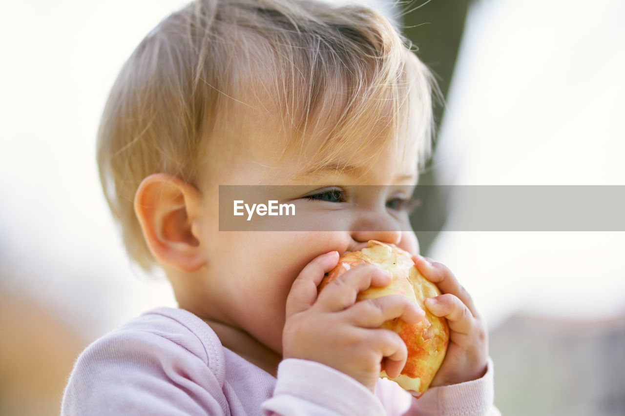 Close-up portrait of cute boy eating food