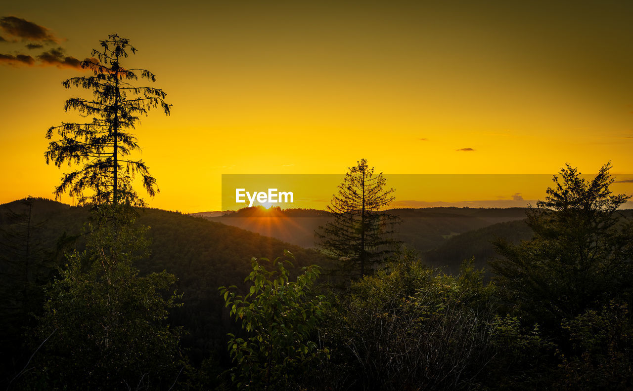 SCENIC VIEW OF SUNSET OVER MOUNTAINS