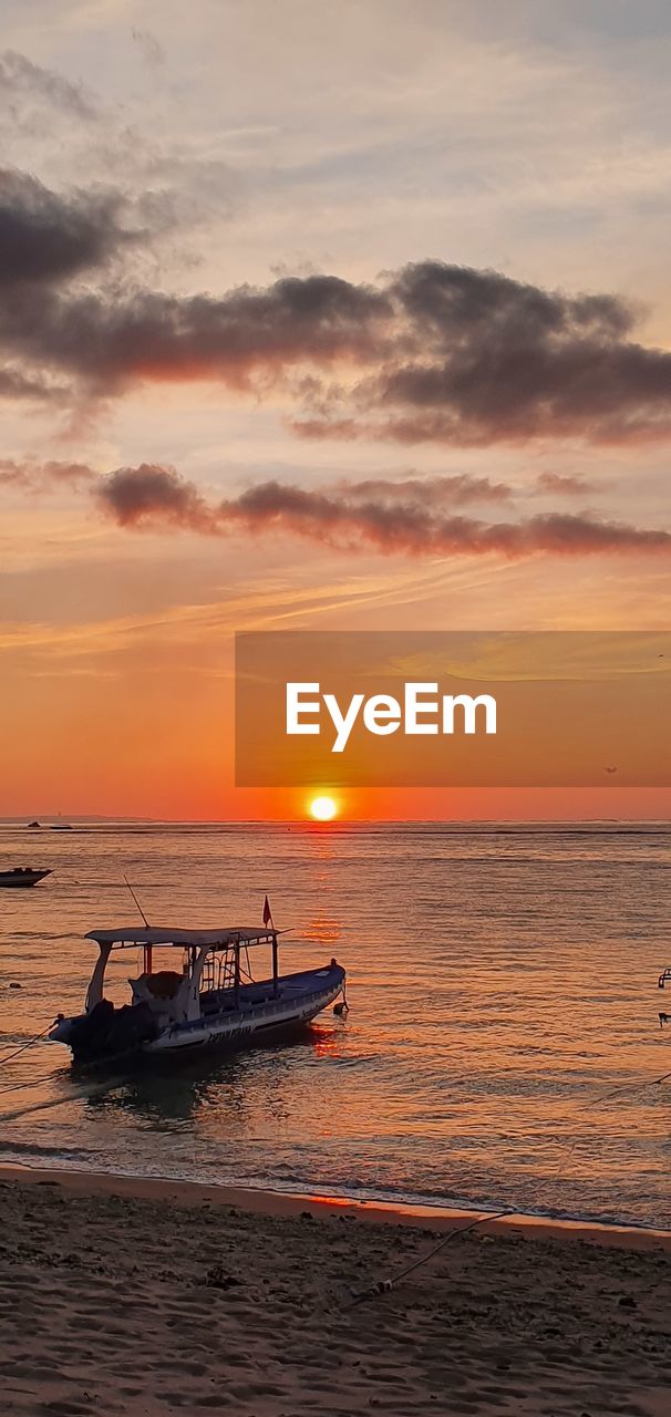 SILHOUETTE BOAT IN SEA AGAINST ORANGE SKY