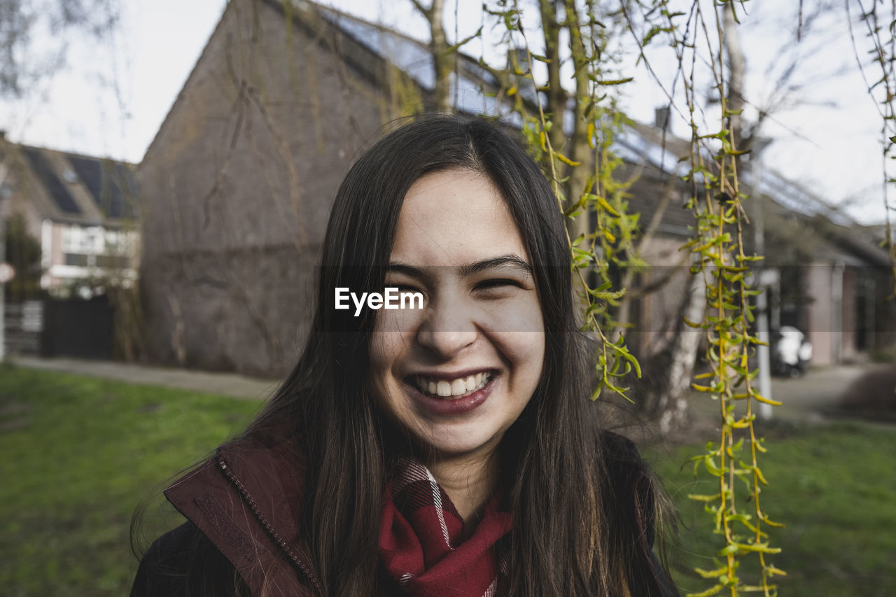 Young smiling woman is on the walk in spring day, outdoor view.