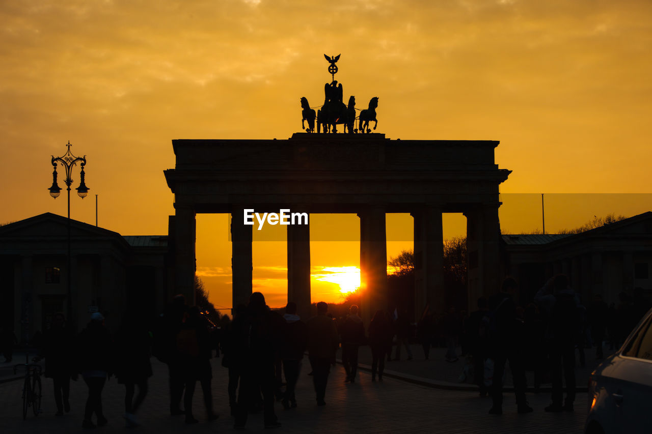 Low angle view of silhouette brandenburg gate against sky during sunset