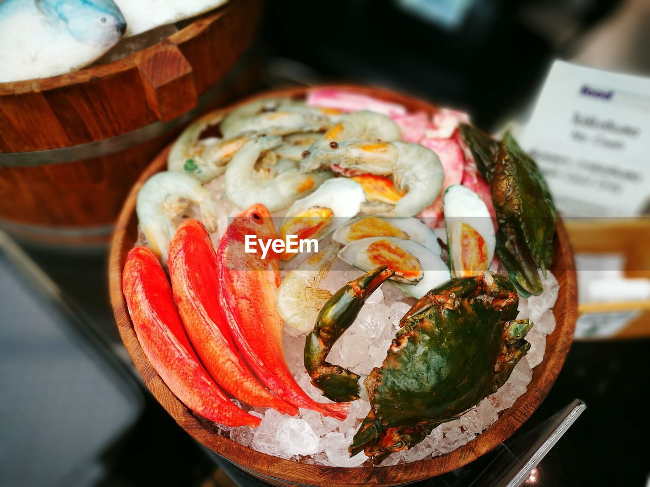 Close-up of fish on crushed ice in container