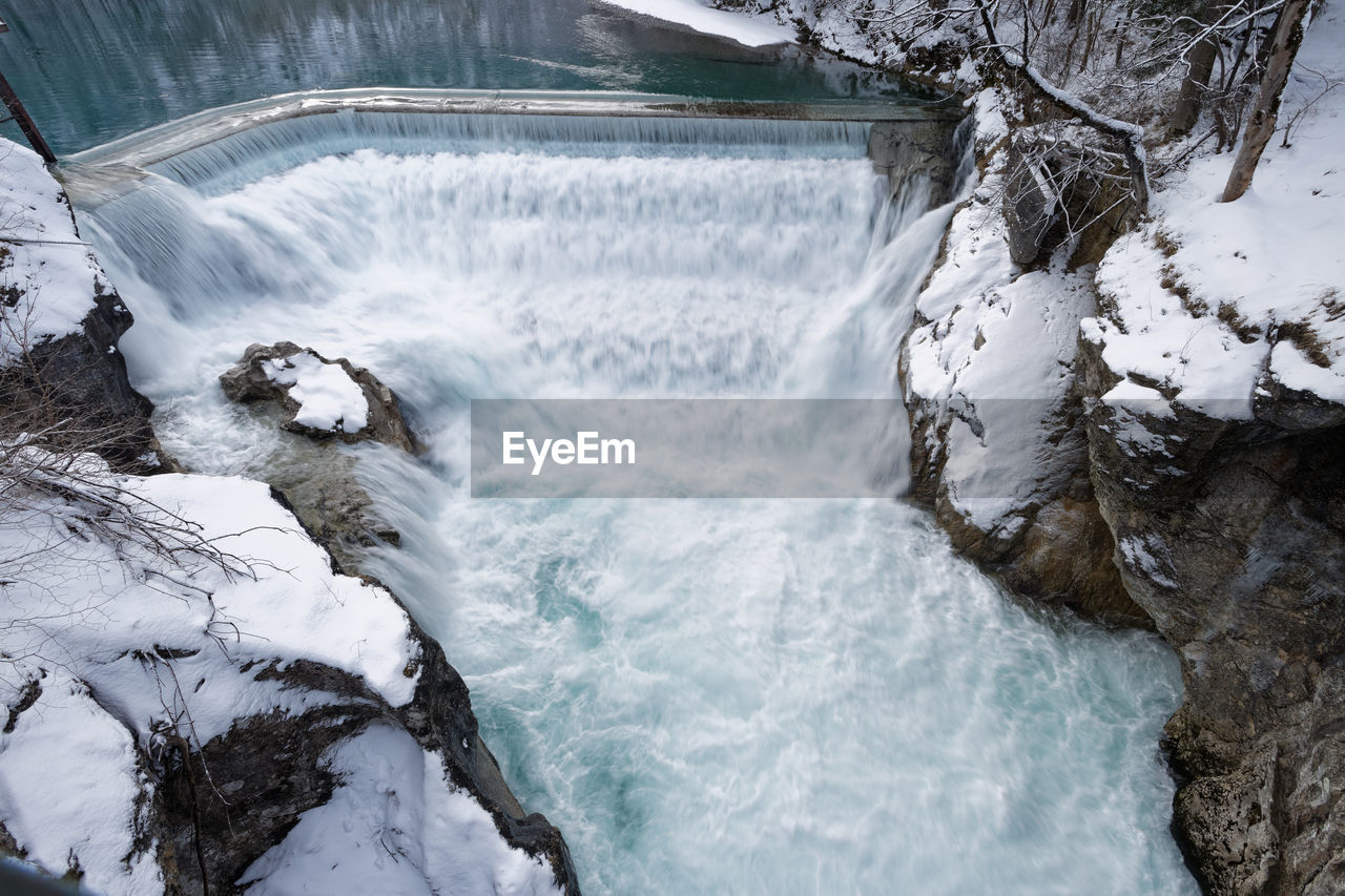 HIGH ANGLE VIEW OF WATERFALL IN SNOW