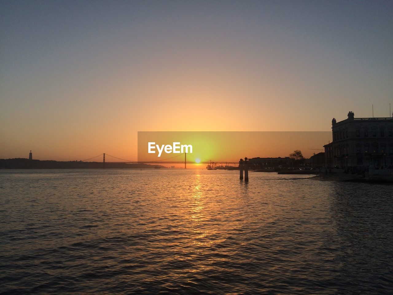View of river against clear sky during sunset