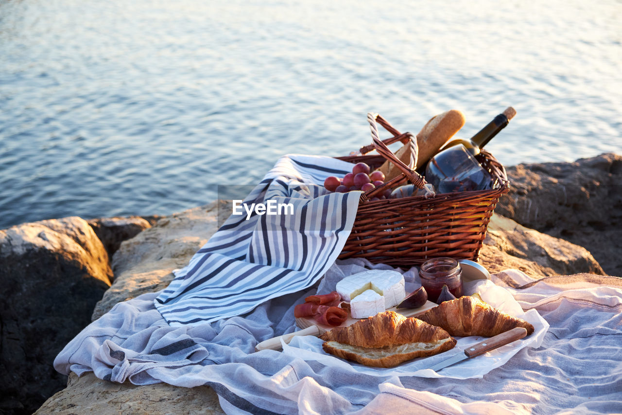 Close-up of food in basket by lake