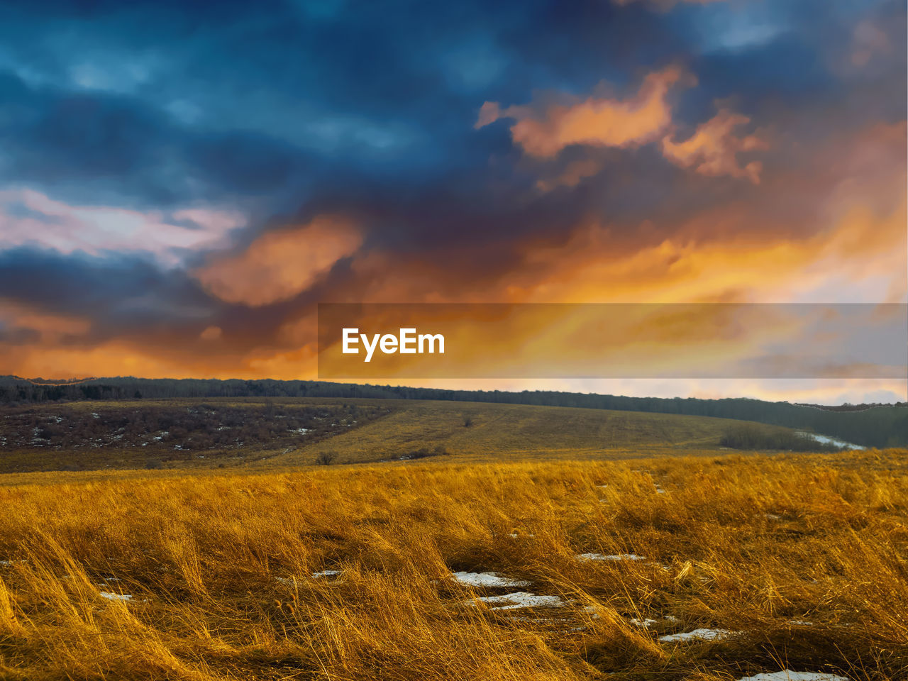 Scenic view of field against sky during sunset