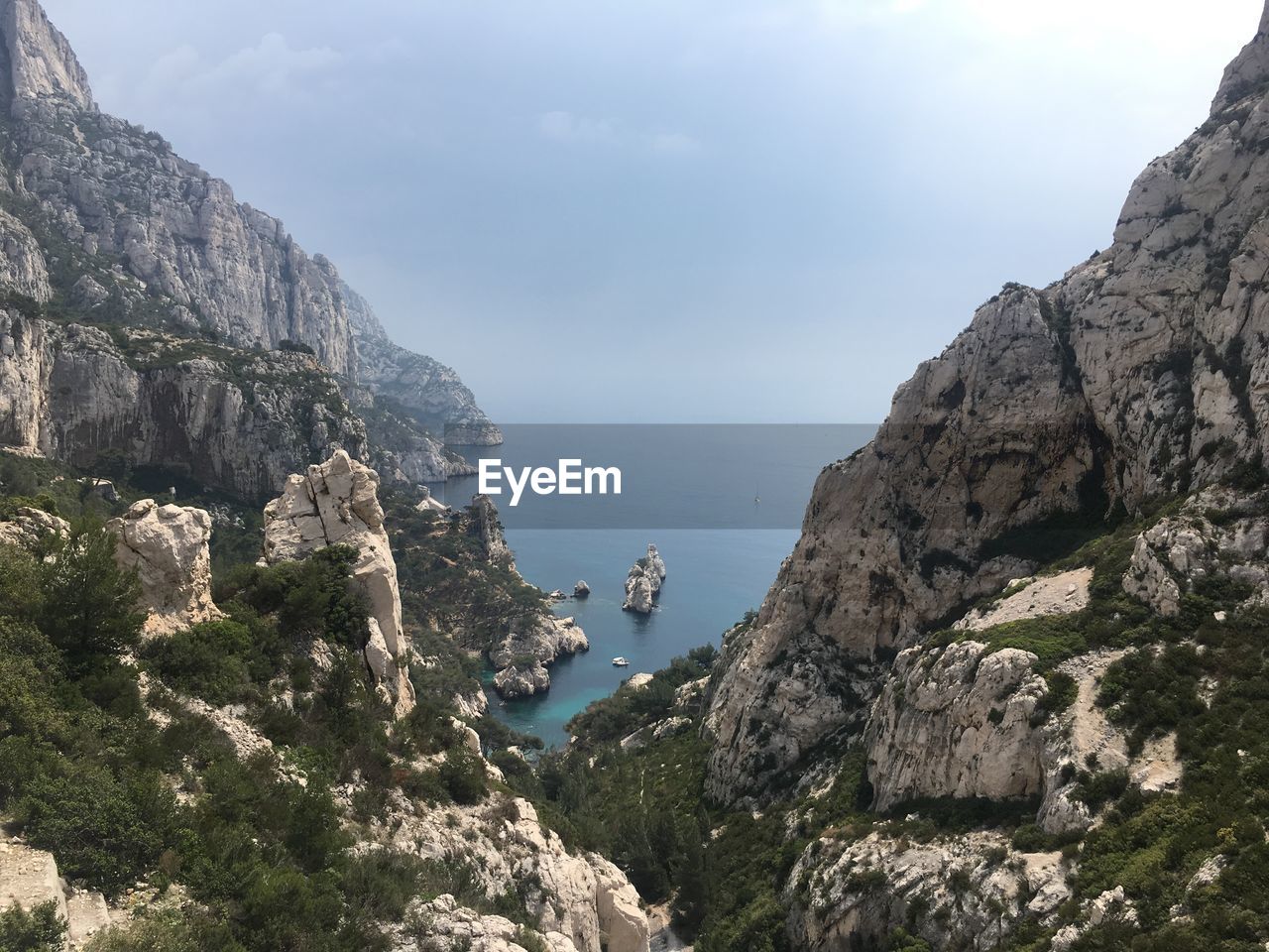 Rock formations by sea against sky