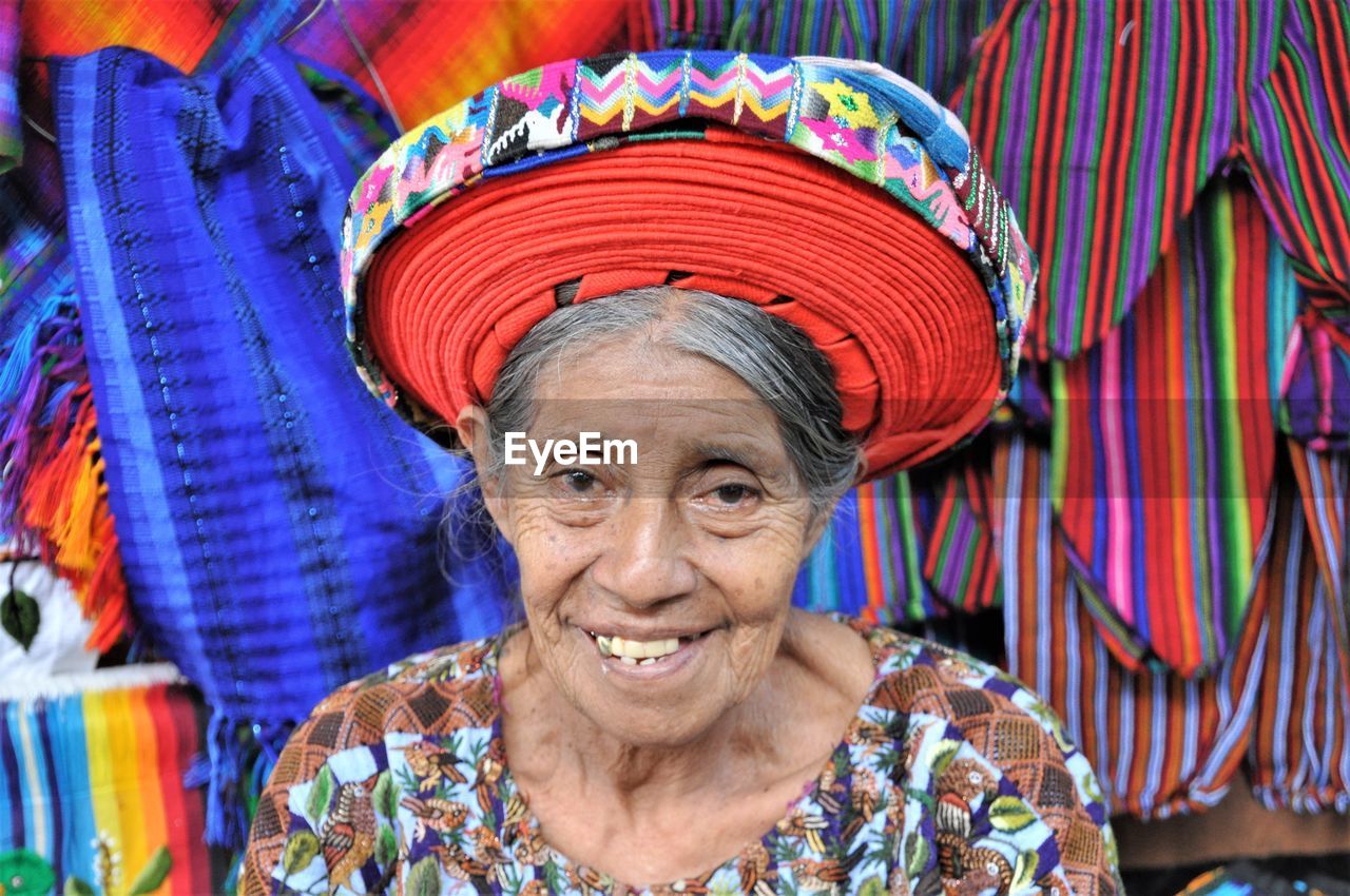 PORTRAIT OF A SMILING YOUNG WOMAN WEARING MASK