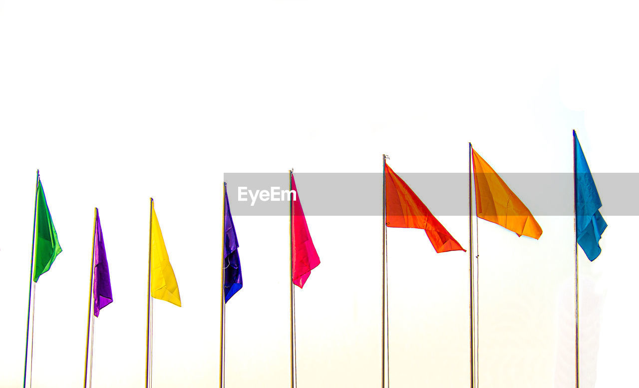 CLOSE-UP OF FLAGS AGAINST WHITE BACKGROUND